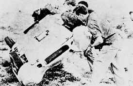 Bystanders roll the car back on its feet.